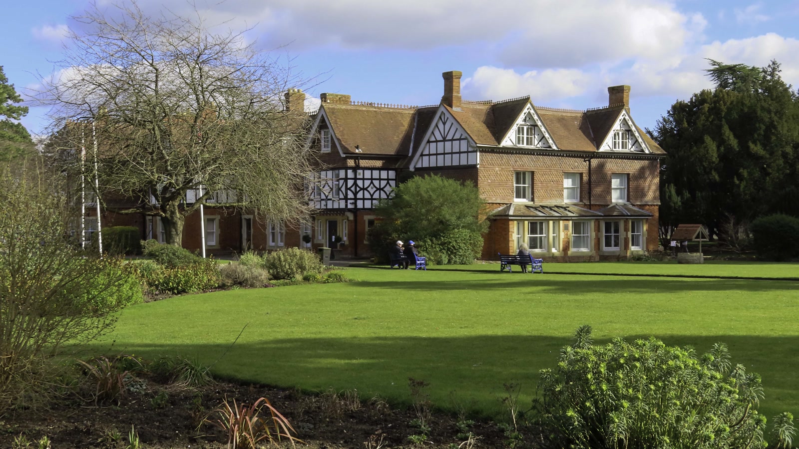 Victorian stone facade and grounds of Garth House tucked within Garth Park in Bicester