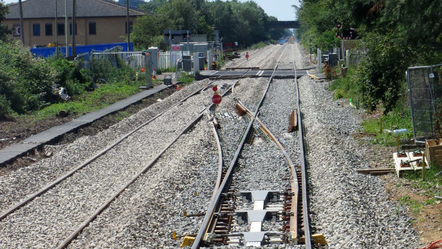 Railway tracks and road barriers at the London Road level crossing in Bicester, photographed in June 2014.