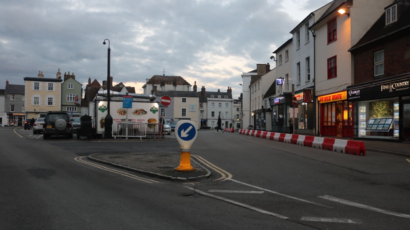 Market Square in Bicester showing historic town centre buildings, restaurants and outdoor seating.