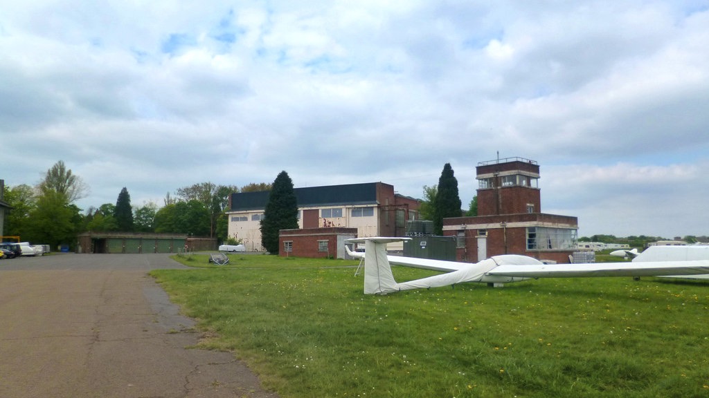 The 1930s RAF Bicester Watch Office tower, historic hangars, and gliders resting on the grass airfield, photographed in May 2013.
