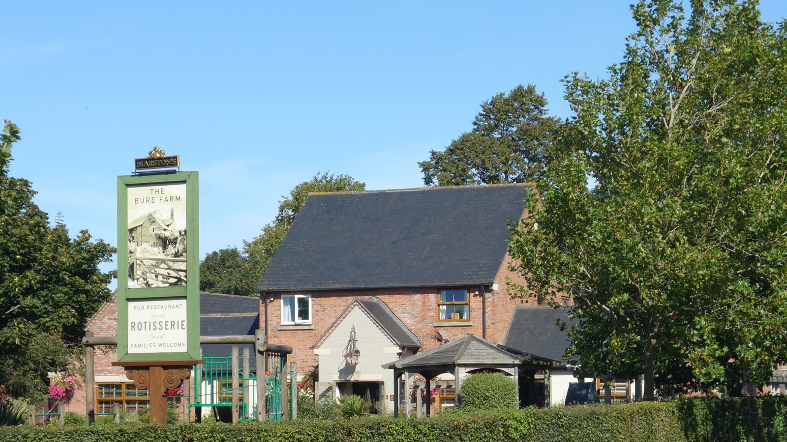 Exterior and patio entrance of The Bure Farm family-friendly pub in Bure Park, Bicester.